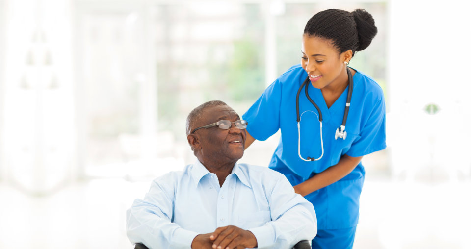 black woman doctor with black old man sitting